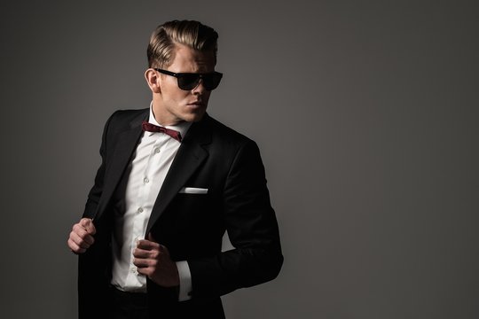 Confident sharp dressed man in black suit