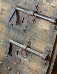 old lock with big deadbolt to close the door of the medieval cas