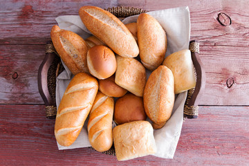 Assorted crusty fresh bread rolls in a basket - 82746609