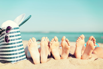 three women lying on the beach