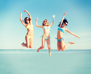 girls jumping on the beach