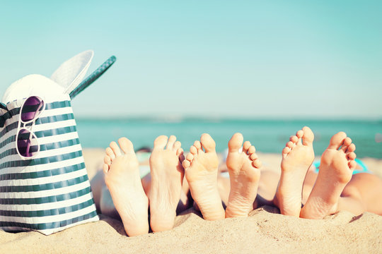 Three Women Lying On The Beach