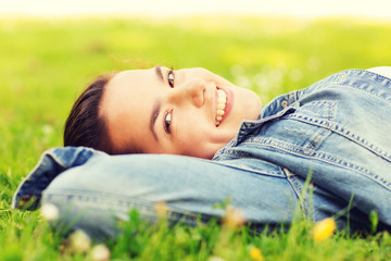 smiling young girl lying on grass