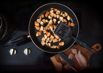 Chopped chicken fillet fried on frying pan