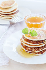 Pile of pancakes with honey
