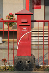 Red Thailand postbox standing infront of the post office.