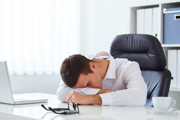 Young businessman in white shirt sleeping