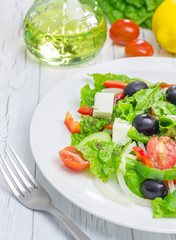 Greek salad on a white plate closeup