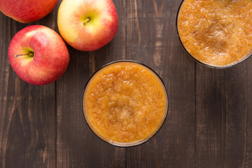 Top view red apples smoothie on wooden background