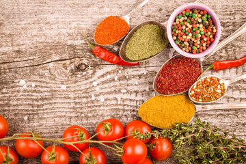 Bunch of cherry tomatoes, herbs, small bowl and antic metal spoo