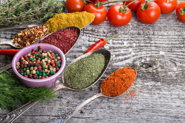 Bunch of cherry tomatoes, herbs, small bowl and antic metal spoo