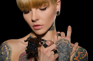 tattooed young woman with tattoo machine