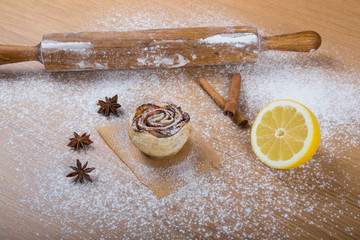 Homemade pastries on a light wooden table with flour