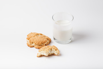 Cookies with cottage cheese - sochnik and glass of milk on a lig