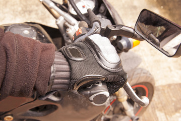 Fototapeta na wymiar Biker hand rests on the steering wheel motorcycle