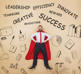 Manager in cloak of superman. Studio shot on a beige background.