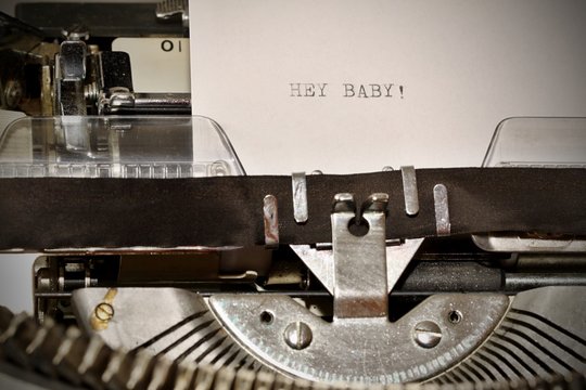 Text Hey Baby typed on old typewriter