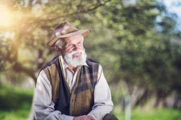 Fototapeta premium Senior farmer outside in beautiful summer nature