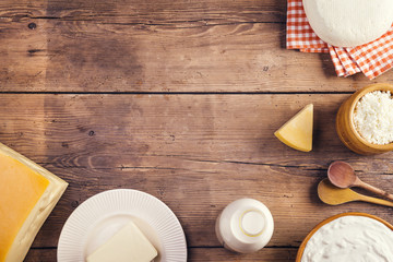 Variety of dairy products laid on a wooden table background