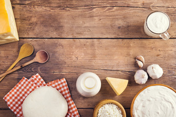 Variety of dairy products laid on a wooden table background