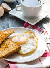 crispy toast with a fried egg and a cup of coffee. breakfast
