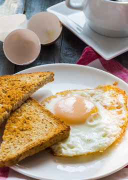 crispy toast with a fried egg and a cup of coffee. breakfast