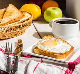 crispy toast with a fried egg and a cup of coffee, fruit, Englis