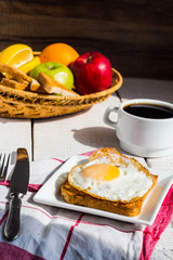 crispy toast with a fried egg and a cup of coffee, fruit, breakf