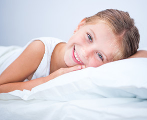 little smiling girl in a bed