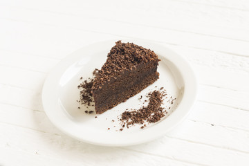 piece of chocolate cake on a white surface