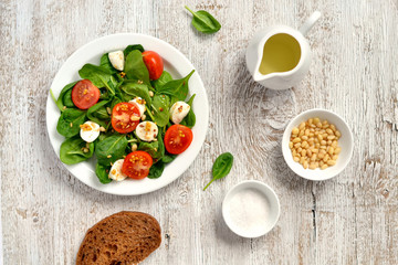 fresh salad with cherry tomatoes, mozzarella and spinach 