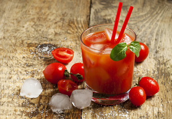 Red cocktail with tomato juice, ice and salt, selective focus