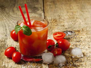 Red cocktail with tomato juice, ice and salt, selective focus