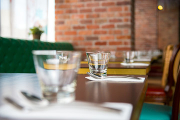 interior of modern restaurant , empty glass on table.