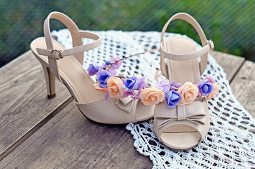 Wedding shoes and the headband on wooden table