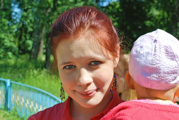 Young woman holding little girl
