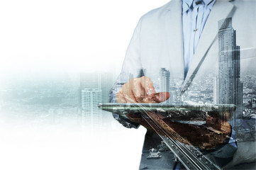 Double exposure of city and businessman on the phone
