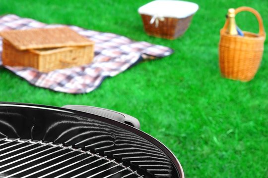 BBQ Grill,Picnic Basket With  Wine, Blanket  On The Lawn