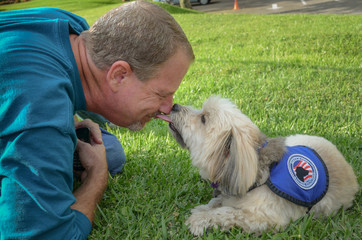 Older man sharing a precious encounter with his service dog
