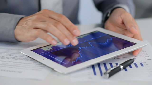 Businessman Analysing Growth With Tablet