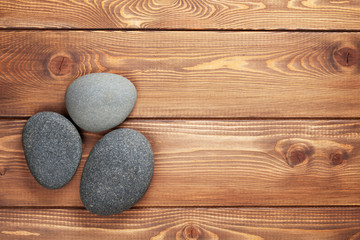 Wooden background with sea stones