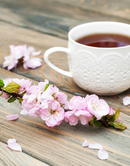 Fototapeta na wymiar Cup of tea and sakura blossom