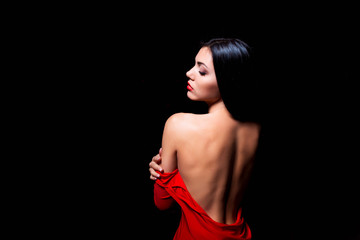 Elegant woman in red dress getting stripped - obrazy, fototapety, plakaty