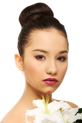Fototapeta premium Beauty face of a woman with flower.