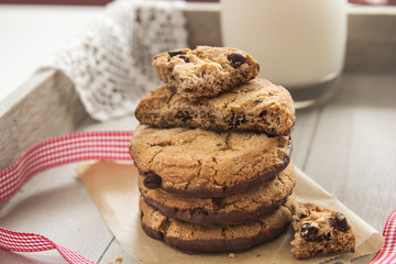 Pile of chocolate cookies with a glass of milk