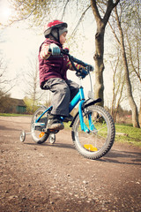 Boy on bike at countryside road