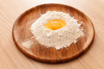 Broken egg on flour