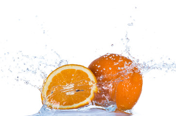 Fototapeta na wymiar Fresh orange in water splash on white background