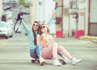 Hipster girlfriends taking a selfie in urban city context - - 82760420