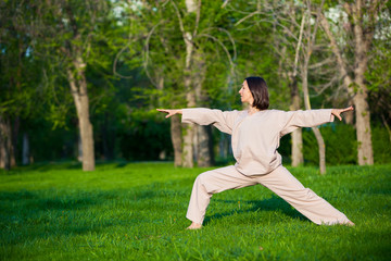 Practicing yoga in the morning, with trees  background